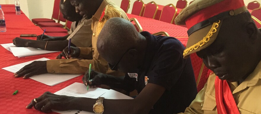 A group of Lou chiefs signing customary guidelines in Wau town on 30 September 2022 (Radio Tamazuj photo)
