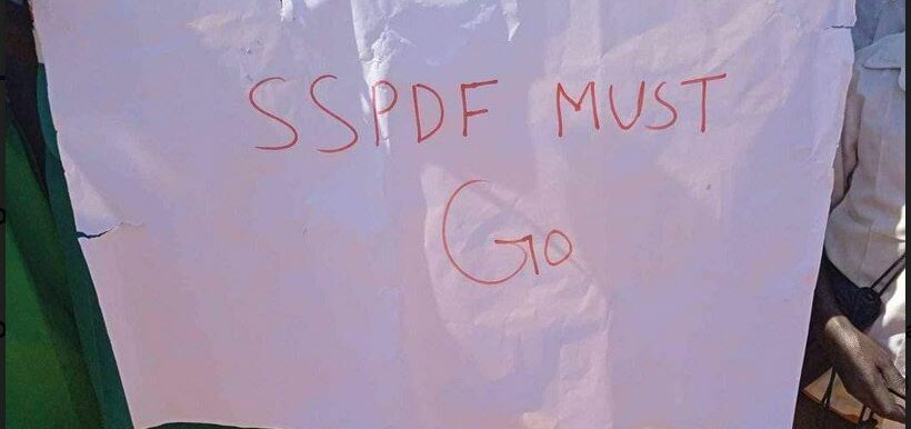 School children hold up a banner demanding the exit of the SSPDF from Abyei. (Courtesy photo)
