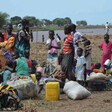 A group of displaced women and children rest on Ethiopian territory after crossing the Baro River from South Sudan. [Photo: UNHCR]