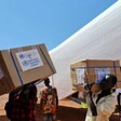 Porters offload a drug shipment organized by WHO to help flood-displaced people in Unity State. (UN photo)